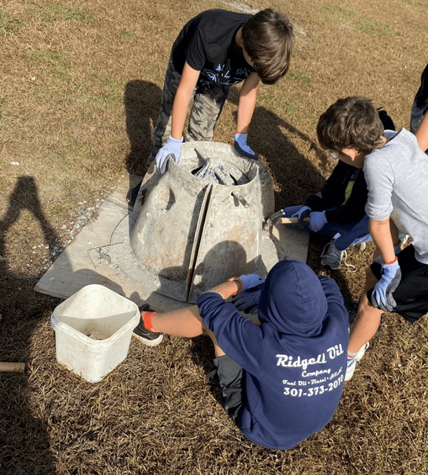 Students taking apart the reef ball mold.