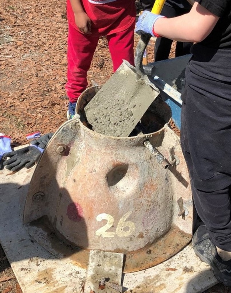 Concrete being shoveled.